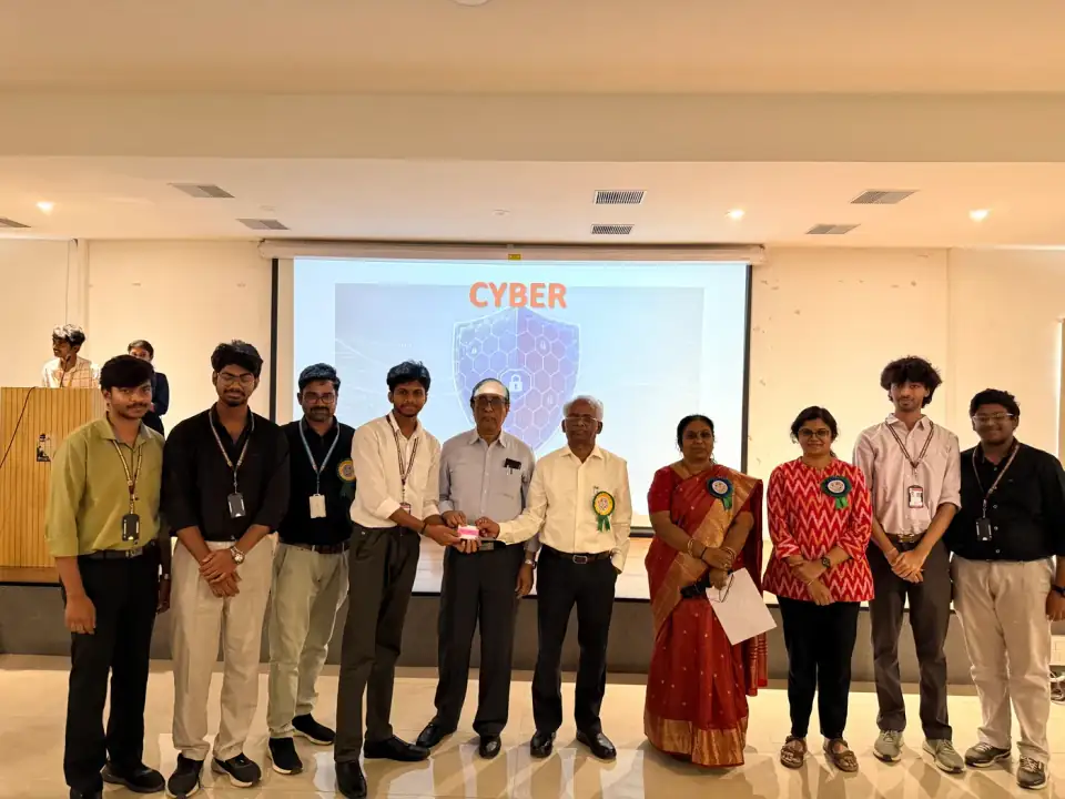 On-stage award presentation at a cybersecurity academic event—recognition for contribution and leadership.